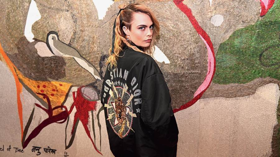 Cara Delevingne at the show, with one of Manu Parekh’s translated canvases.