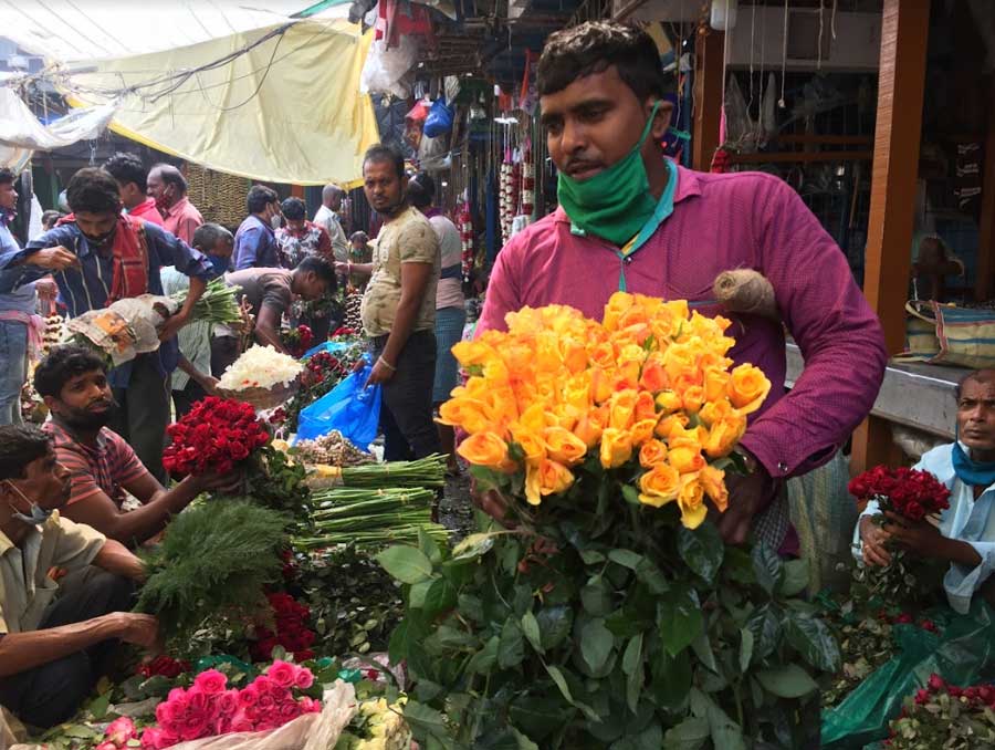 A florist holds a freshly cut bouquet of yellow roses on Friday at a flower market in Kolkata ahead of Valentine’s Day on February 14