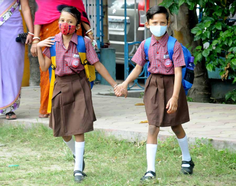 HAND-IN-HAND: A couple of friends hold hands on their way to an open-air classroom in north Kolkata on Tuesday, February 8. The Bengal government launched the 'Paray Sikshalay' programme last month, under which open-air sessions for students from classes I to VII began in every locality from February 7. Chief minister Mamata Banerjee on Thursday said primary schools in the state could be reopened after a few more days following proper evaluation of the Covid-19 situation and talks with school authorities
