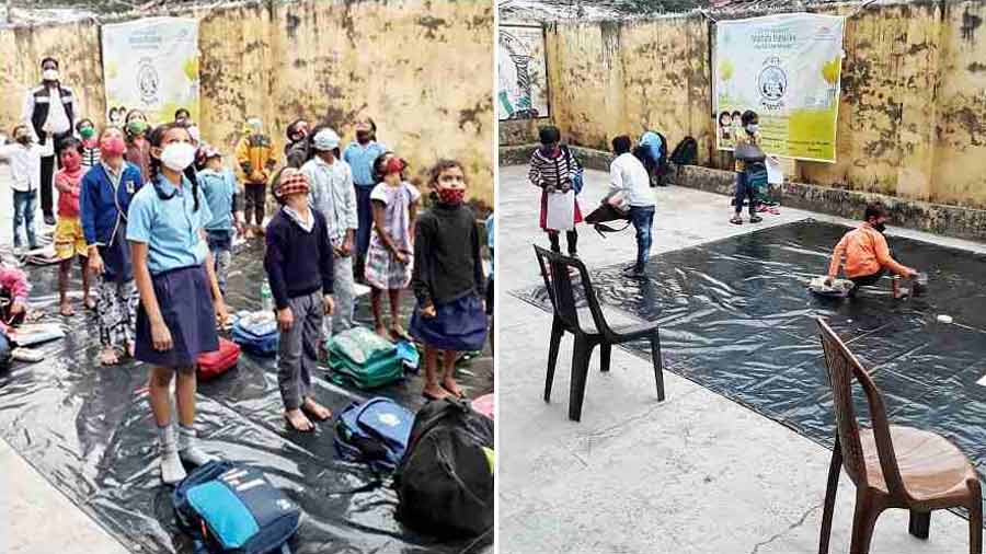 WET CHALLENGE: Students of an open-air classroom on Palmer Bazar Road in central Kolkata look up at the overcast sky on Thursday, February 10. Classes had to be suspended when a drizzle started around 1pm because there was no shade