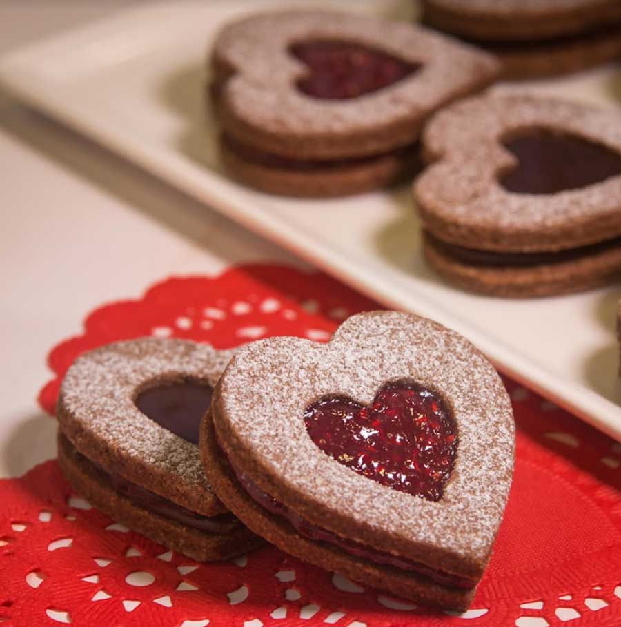 Layered shortbread with jam peeping through a hole, Linzer Heart-Shaped Cookies will melt your partner’s heart. A year-round staple in bakeries in the US and Germany, the cookies have been traditionally named after Linz, Austria, where they originated. 