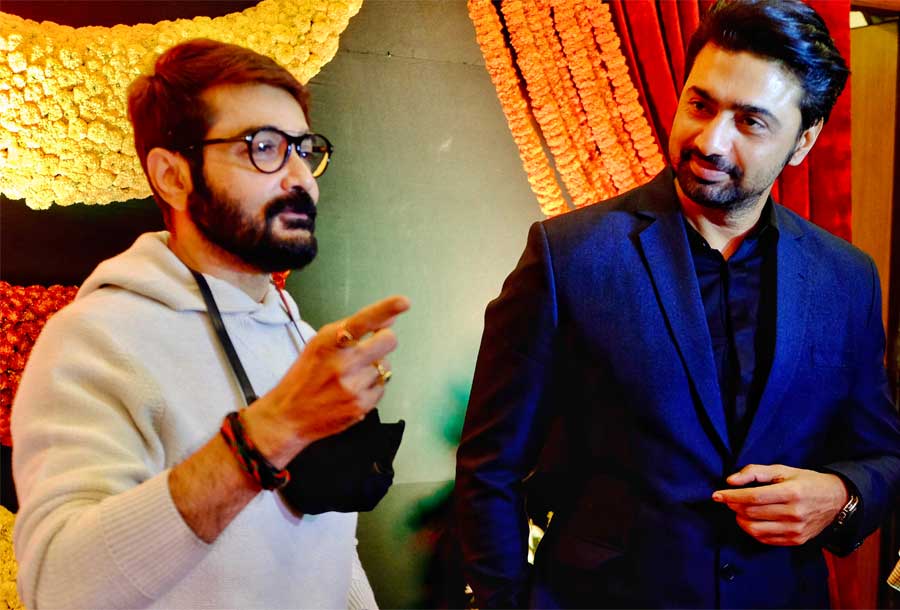 Actor Prosenjit Chakraborty and Dev caught in a candid conversation in an award ceremony on Sunday at Priya Cinema in south Kolkata 