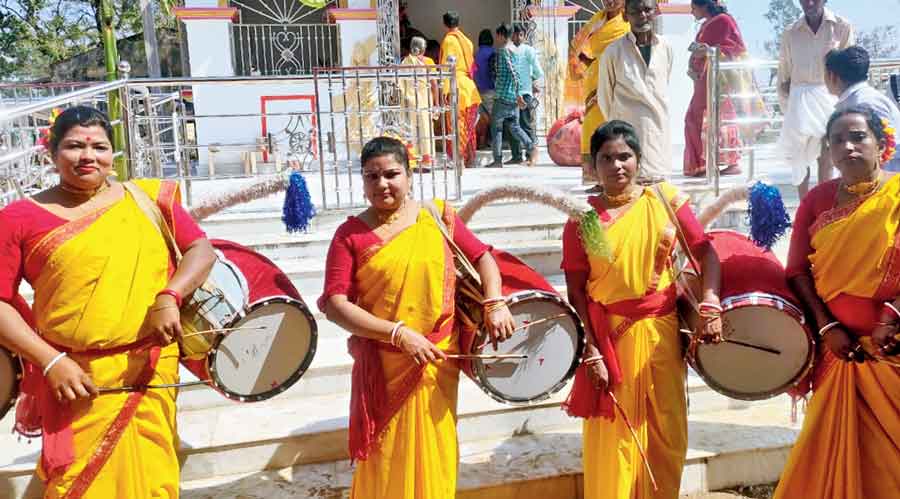 Devotees beat drums at the temple on Monday.