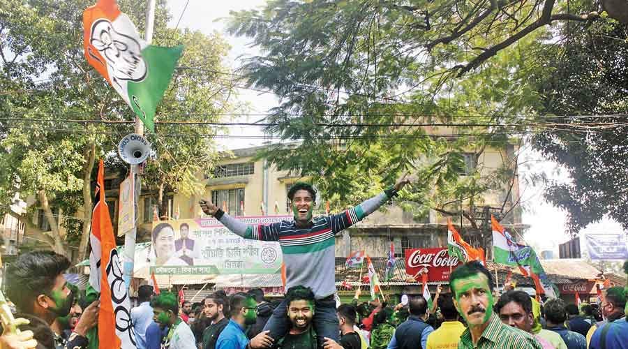 With Trinamul flag in the hand and mounted on a friend’s shoulders, a supporter celebrates the party’s victory in Siliguri on Monday.