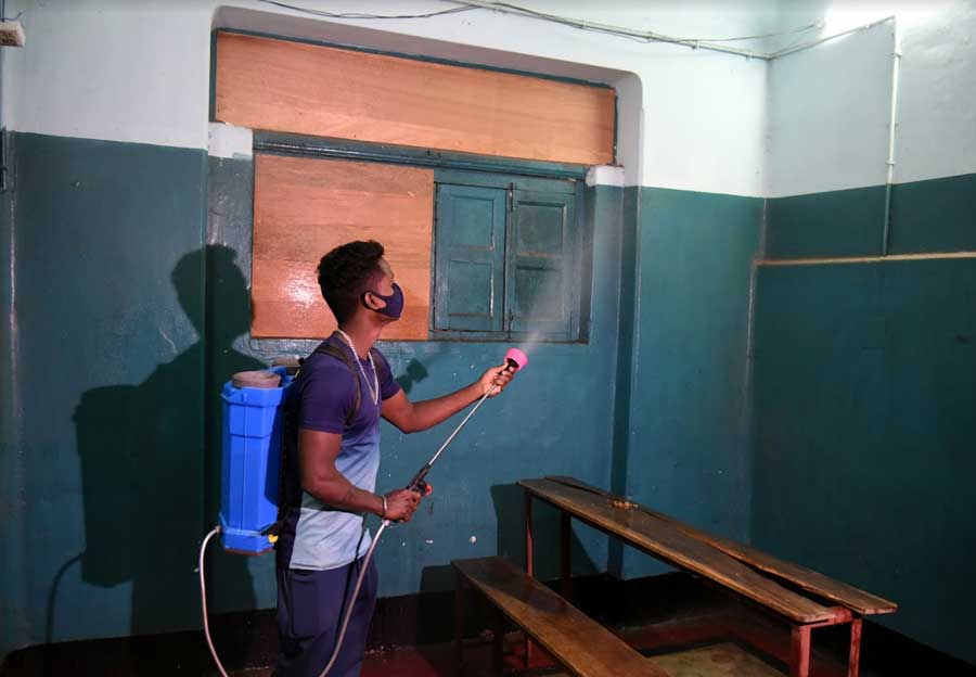 A sanitisation worker sprays disinfectant at Bharatiya Hindi High School in south Kolkata on Tuesday. Primary and upper primary students in the state will return to classrooms on Wednesday