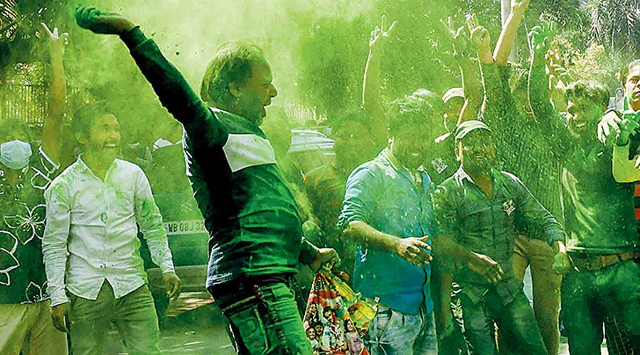 Trinamool Congress supporters celebrate during counting day of four municipal bodies election, at Salt Lake in Kolkata, Monday, Feb. 14, 2022. 