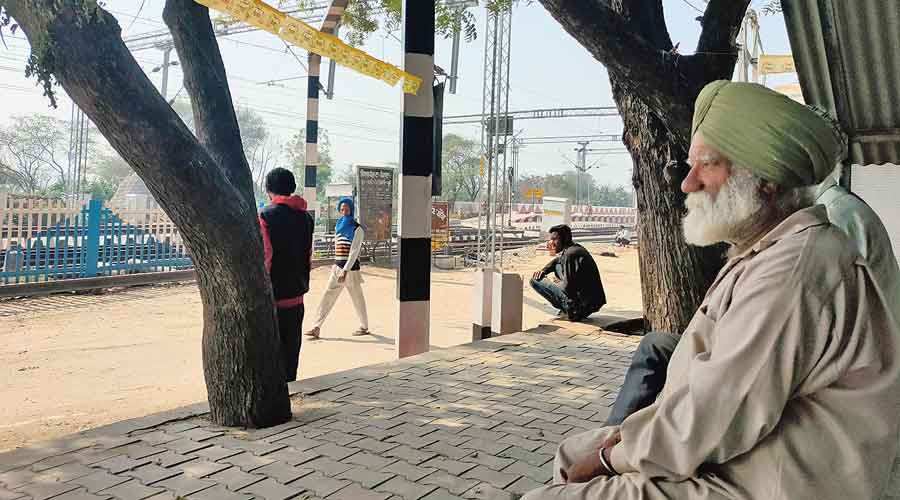 Farmer Netar Singh watches work on the railway line at Kaulseri village in Dhuri, Punjab.