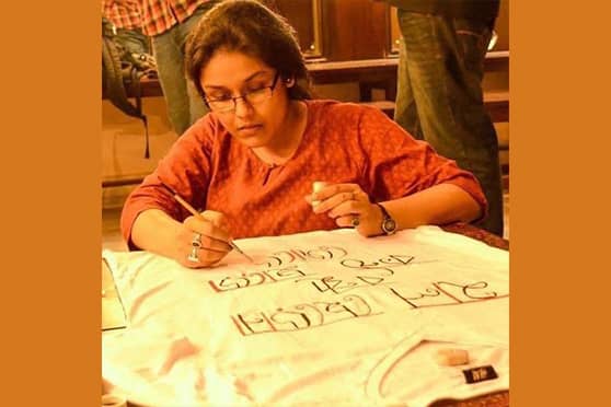 Ekta Bhattacharjee paints a T-shirt. 