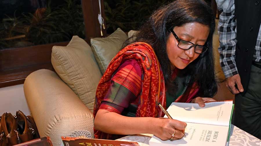 Wahab signs copies of her book for the audience 