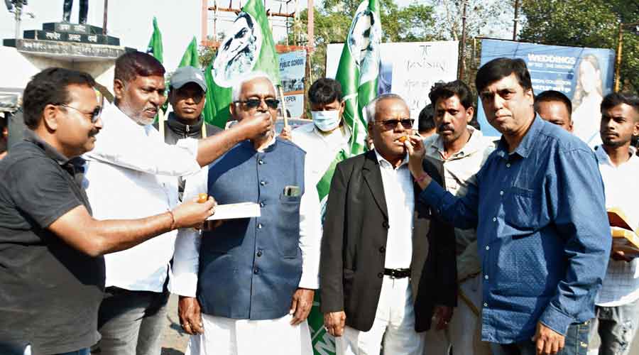 JMM supporters celebrate at Randhir Verma Chowk in Dhanbad on Saturday.