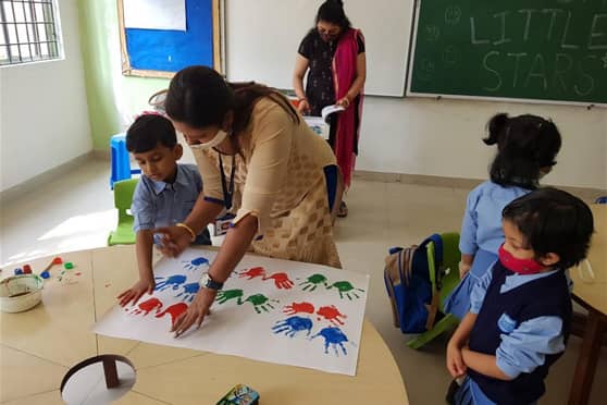 Young students, dubbed as ‘Little Stars’, engaged in fun activities like finger painting on the first day of school.