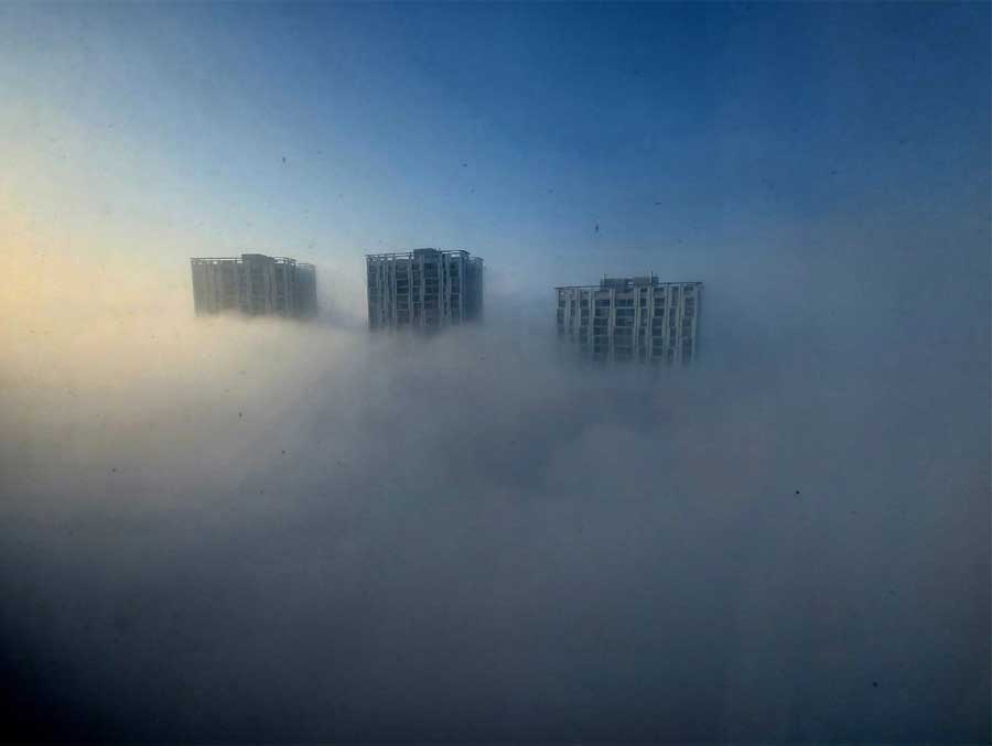 Towers of Urbana engulfed in fog, as seen from another tower in the housing complex at Anandapur, off EM Bypass, on Monday morning