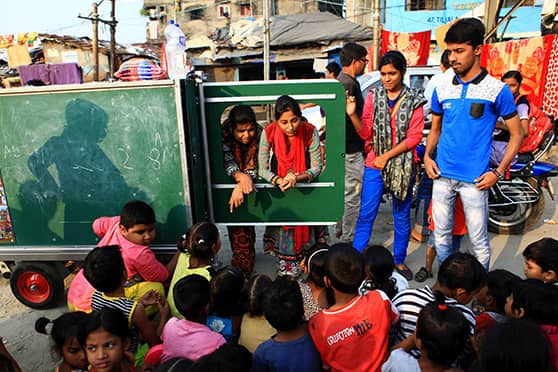 Children from the neighbourhood of Tiljala and Topsia engage in learning from a mobile education cart set up by Ek Tara and Belgium-based non-profit organisation Mobile School.