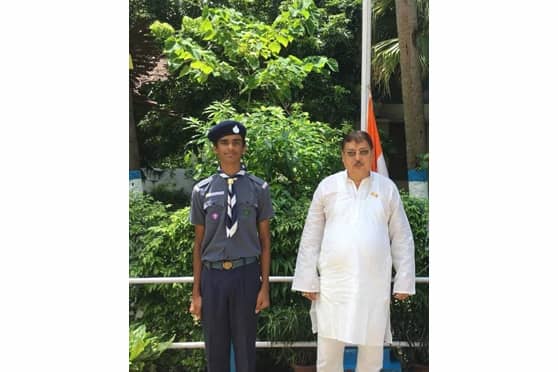 Lakshya with T.H. Ireland, principal of St. James' School, during Independence Day flag hoisting.