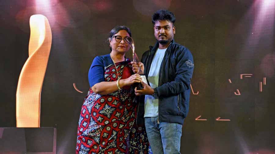 Artist Jayasri Burman presents the Paresh Maity Award to the second runner-up, Akshay Maiti, for his work, ‘Structural Anatomy’