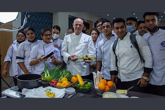 London-based Sicilian chef Enzo Oliveri poses with students of IIHM.