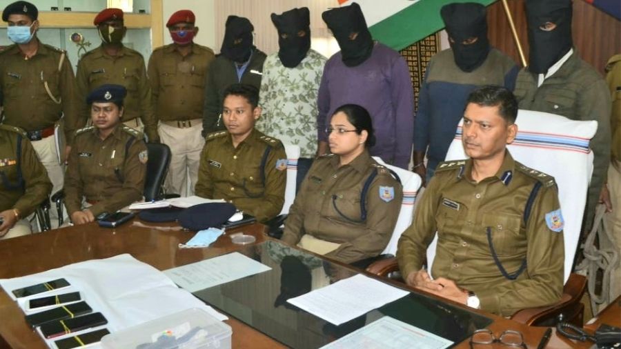 SSP Sanjeev Kumar and other officials with the arrested five extortionists (face cover) during the press conference 