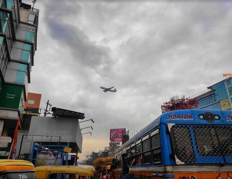 An aeroplane navigates an overcast Kolkata sky on Friday morning