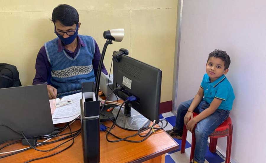A kid bides his time at an Aadhaar centre in north Kolkata as an official verifies his documents. Kolkata Municipal Corporation uploaded this photograph on their Facebook account on Friday