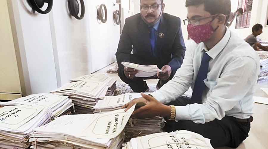 Officials busy in verifying the fragile case records of Odisha High Court.
