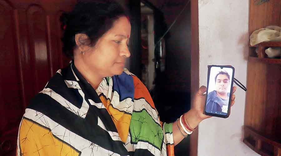 Mother of Arambagh resident  Debarghya Pore, who is stranded in Ukraine, shows his picture on Friday.