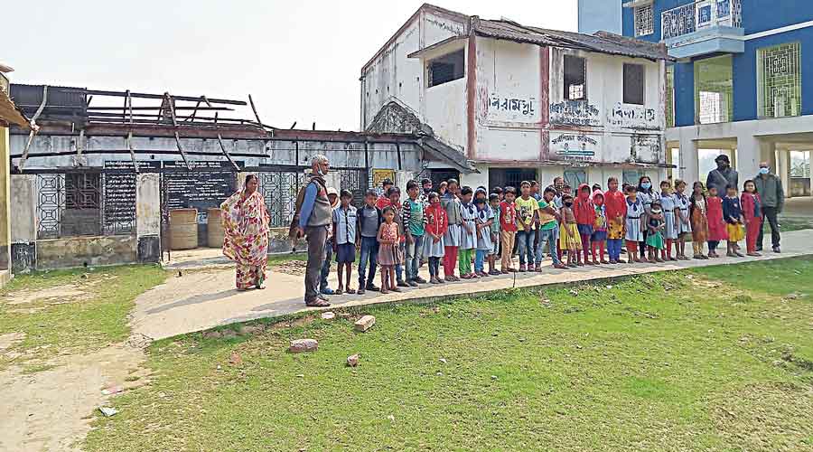 Students of Biramput Primary School attend classes  at an adjacent cyclone shelter.