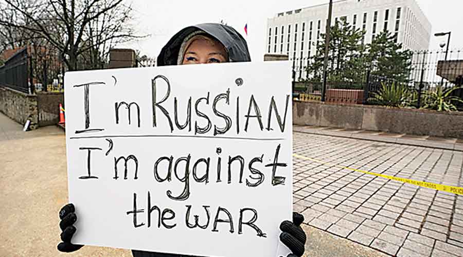 Anna, a Russian national, holds a sign in protest against Russia’s invasion  of Ukraine in Washington  on Friday. 