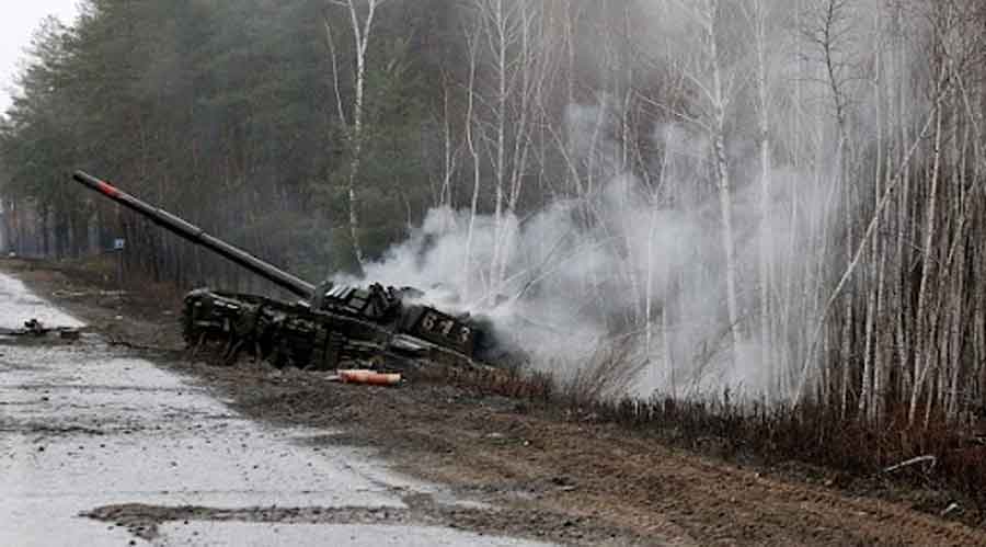 Smoke rises from a Russian tank destroyed by the Ukrainian forces on the side of a road in Lugansk region on Saturday.
