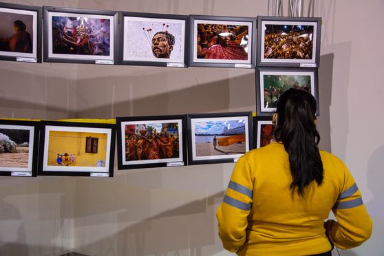 Students browse the photographs on display at the exhibition. 