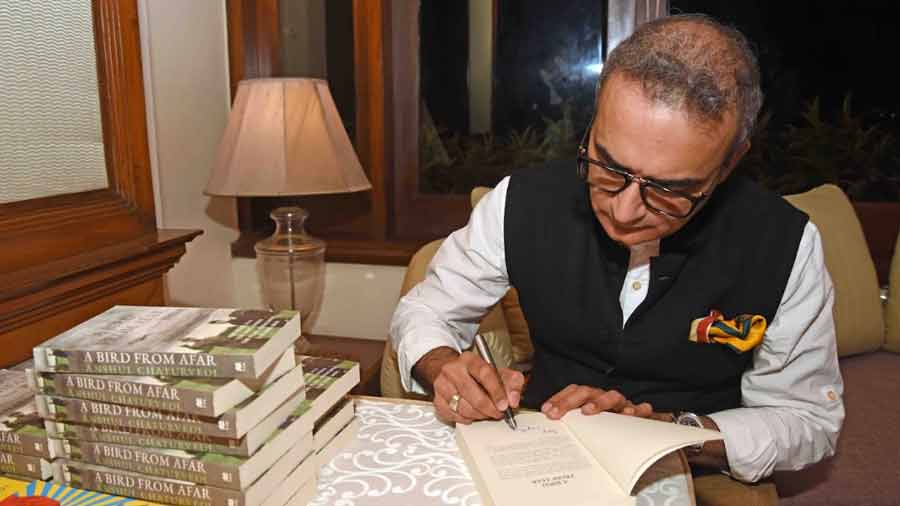 Chaturvedi signs copies of his latest book, 'A Bird from Afar'