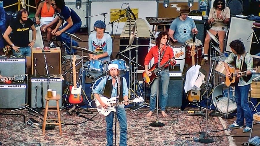 Rob Stoner (in a red shirt) playing bass to the right of Bob Dylan on the Rolling Thunder Revue in 1976 at the University of Florida Stadium in Gainesville. 