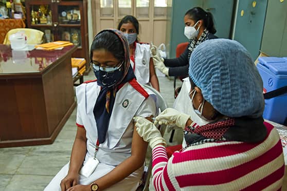 A girl gets her first shot at Bethune Collegiate School on Day 1 of the COVID vaccination drive for 15-18-year-olds in India. Over 12.3 lakh youngsters were administered vaccine doses across the country till 3pm on January 3. 