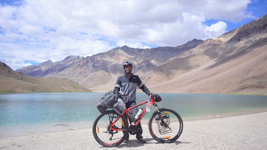 Jyotishka Biswas with his trusted bike in front of Chandra Taal in Himachal Pradesh