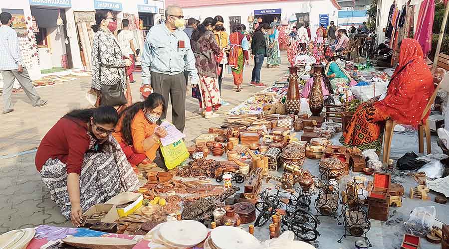 Visitors browse home decor items at Saras Mela hours before it  was closed down due to fresh Covid restrictions.