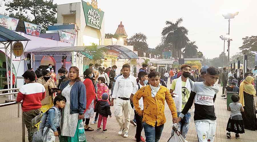 Revellers walk out of Nicco Park on Sunday, many of them without masks
