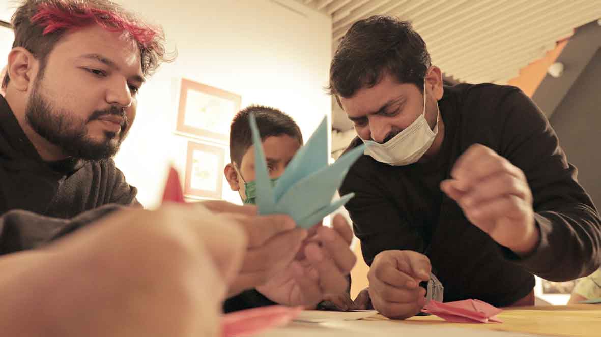 Upal Sengupta (right), a resident of AE Block, conducts the  origami workshop