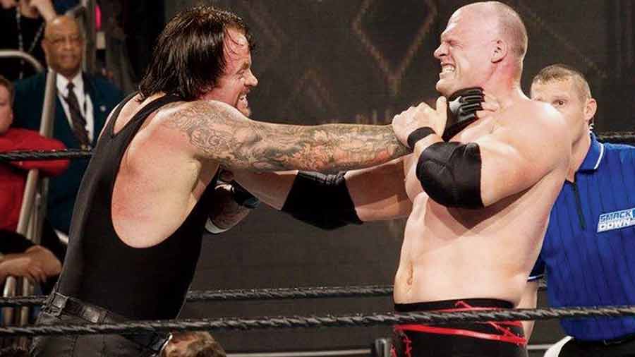 Glenn Jacobs (as Kane) in action against fellow professional wrestler Mark Calaway (as The Undertaker)