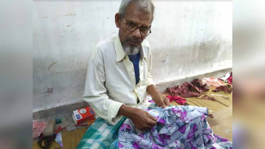 Abdul Rahman is the oldest employee at this tailoring shop and has worked here for over seven decades.