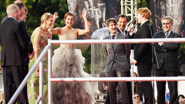 J.K. Rowling, Emma Watson, Jason Isaacs, Daniel Radcliffe and Rupert Grint on stage during the world premiere of Harry Potter and The Deathly Hallows — Part 2 in 2011. Now, the Watson-Radcliffe-Grint generation has been distancing itself from Rowling.
