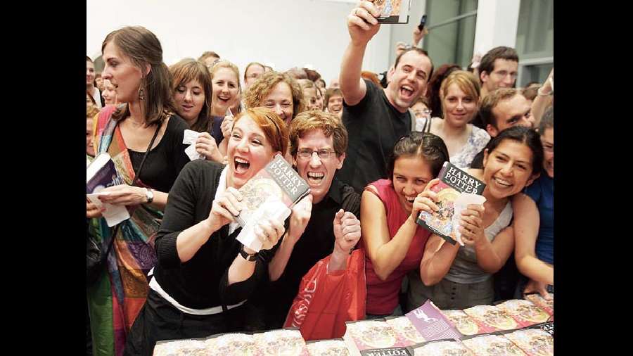 Fans hold the last Harry Potter book by J.K. Rowling — Harry Potter and the Deathly Hallows —at a bookstore after its release in 2007 at the height of Potter-mania.