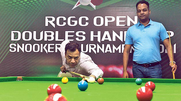 Winners Rajesh Tulsian (right) and Amit Mundra engaged in an intense game during the last leg of the finals of the RCGC Open Doubles Handicap Snooker Tournament.