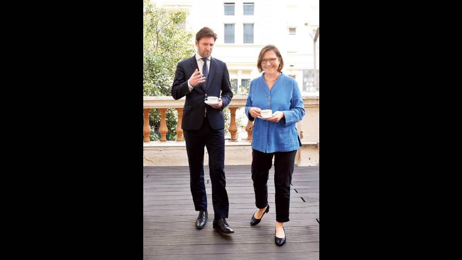 Nicolas and Astrid take a stroll with a cup of tea.