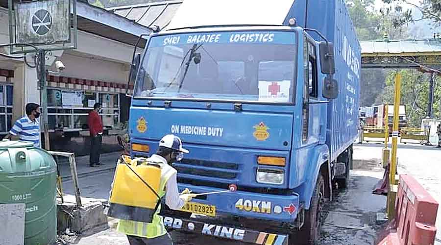 A worker sanitises a truck at Rangpo, a Sikkim town  located on the Bengal border.