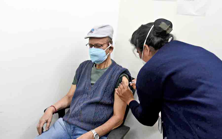 Saurindra Mohan Kolay, 82, gets the booster dose of Covaxin at a private hospital in Dhakuria on Monday. 