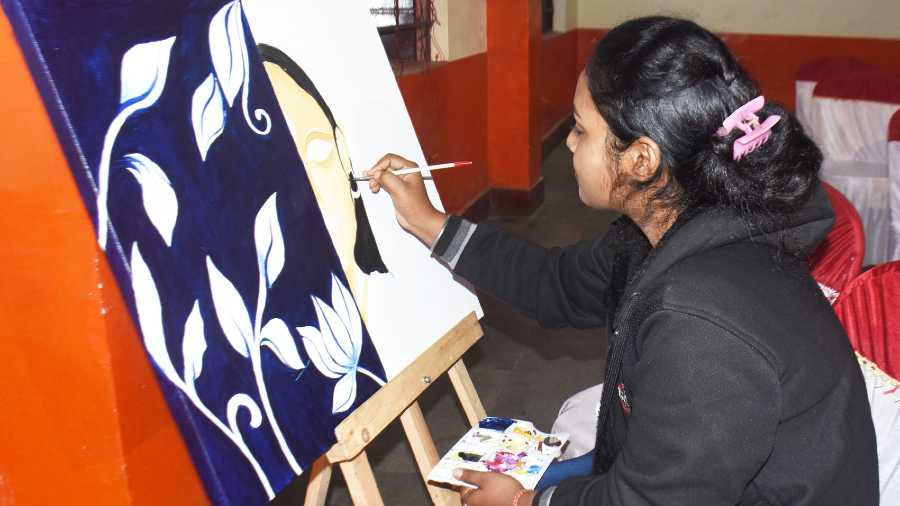 An artist giving the final touch her artwork.