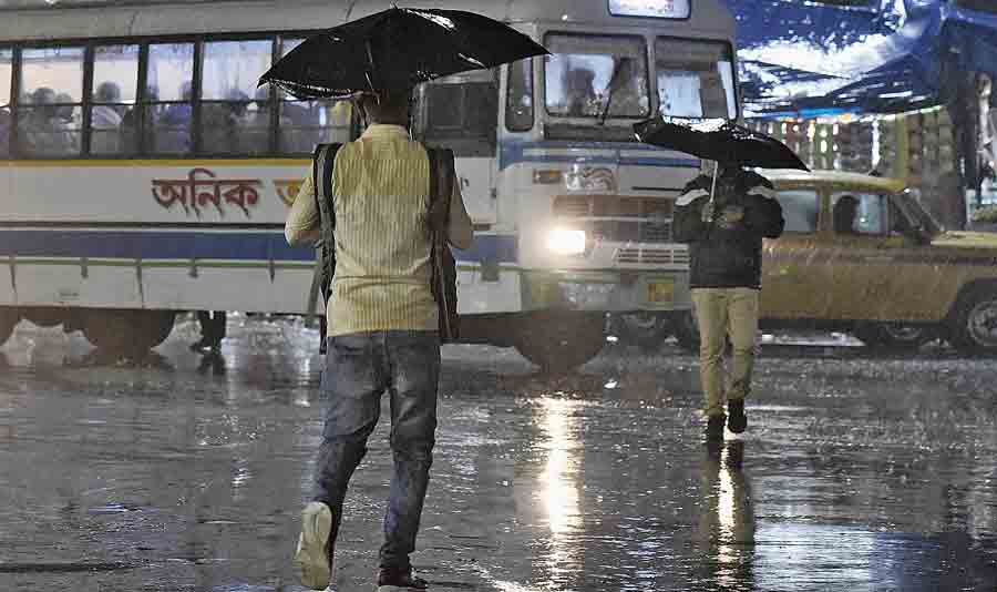 A pedestrian walks in the rain on Tuesday evening. 