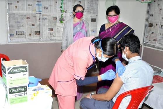 A student gets his first dose at a joint vaccination camp organised by Birla High School and Sushila Birla Girls’ School as Koeli Dey (left), principal of Sushila Birla, and Loveleen Saigal, principal of Birla High, look on.