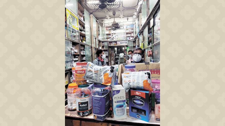 A medicine shop near Baisakhi Abasan with Covid self-test kits displayed on the counter. 
