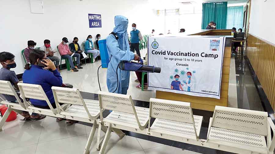 Sanitisation taking place in the Terminal Building vaccination centre on Saturday as school students await their turn for a shot.