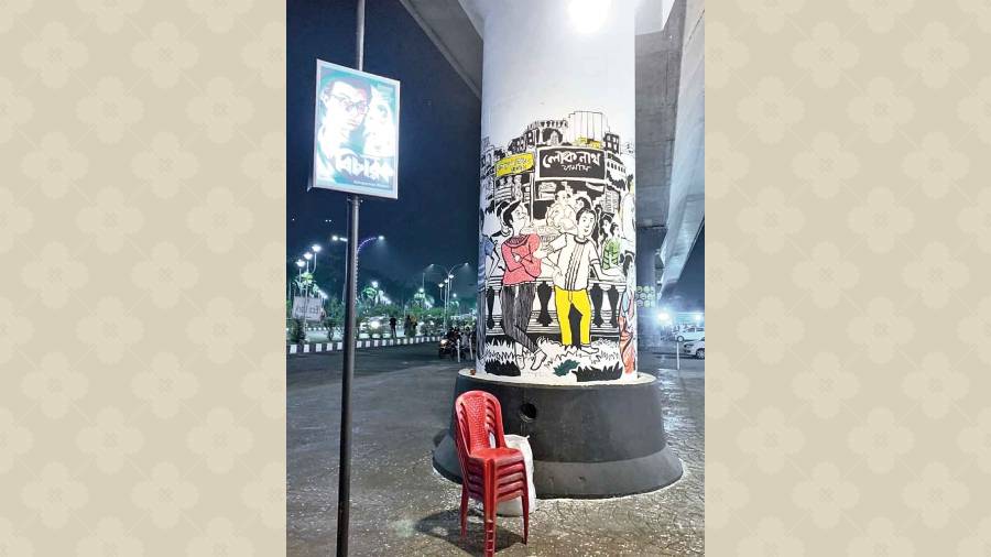 A pillar on the pavement done up with a cartoon